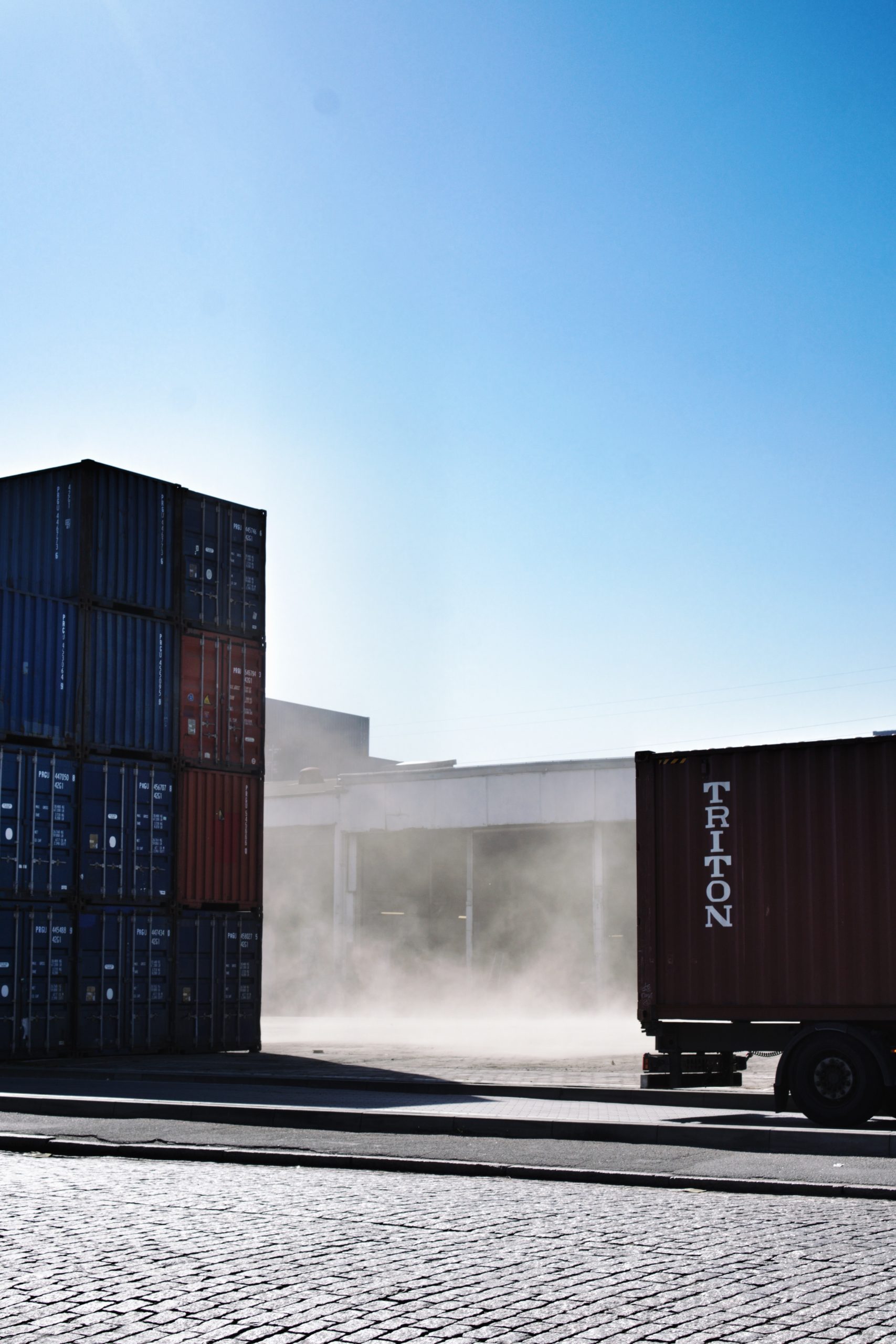 Smoke and dust between containers and truck in harbor of Hamburg, Germany.